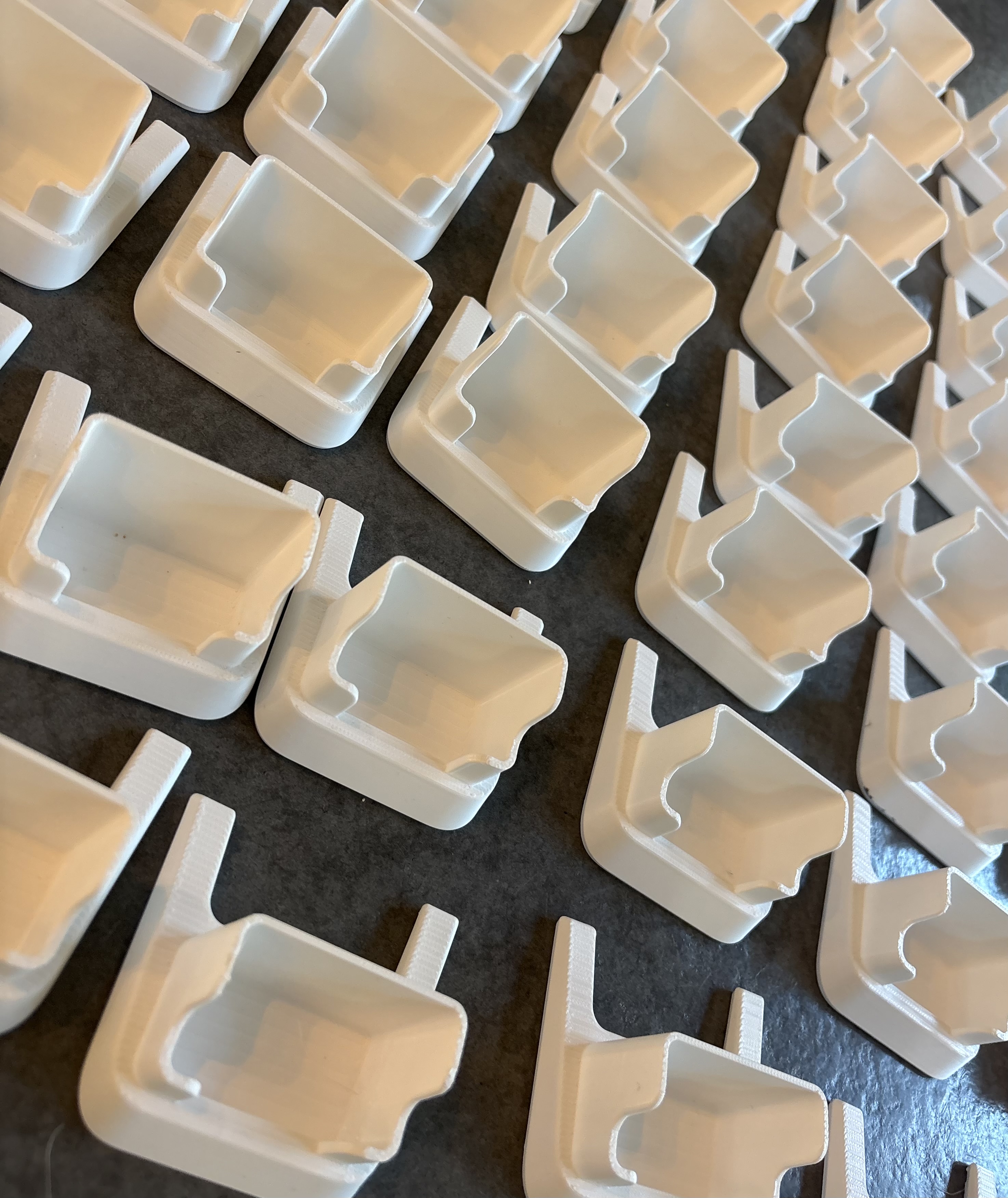 Vita 3D-printade ställ placerade i rader vid serieproduktion